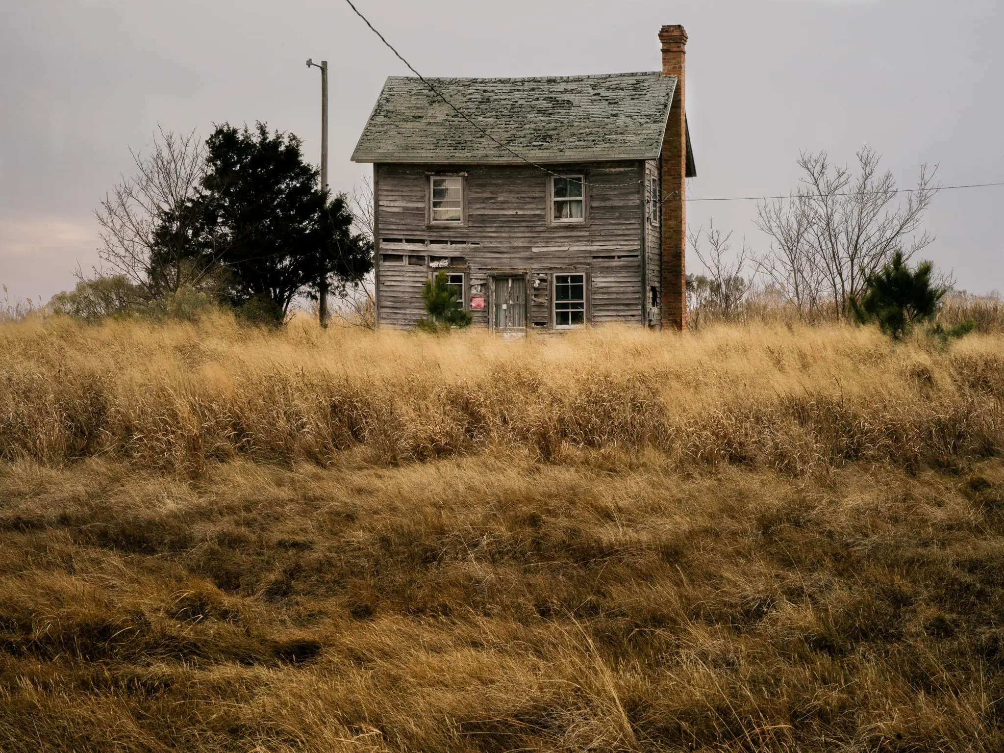A vacant home in Hoopersville decays in the expanding marsh.