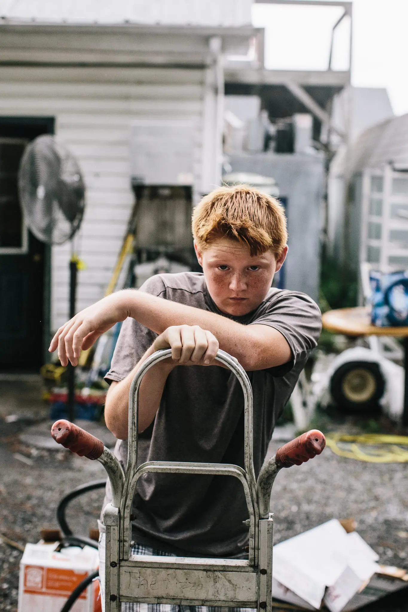 Eddie Chandler III, 14, works outside of his mother's pizza business.