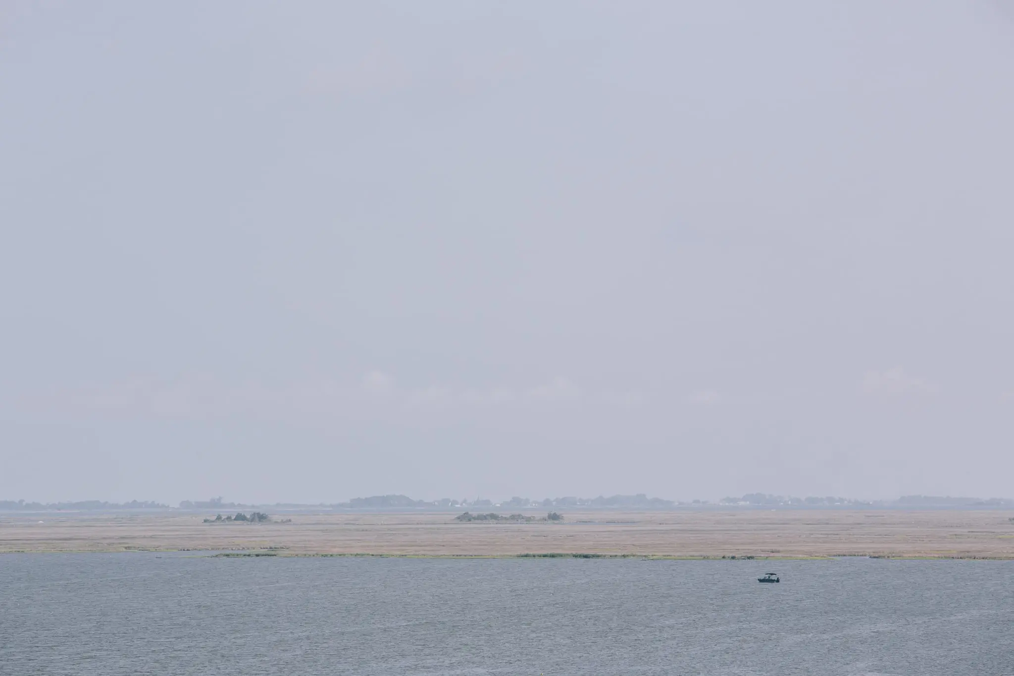 A boat navigates the bay near Jane's Island.