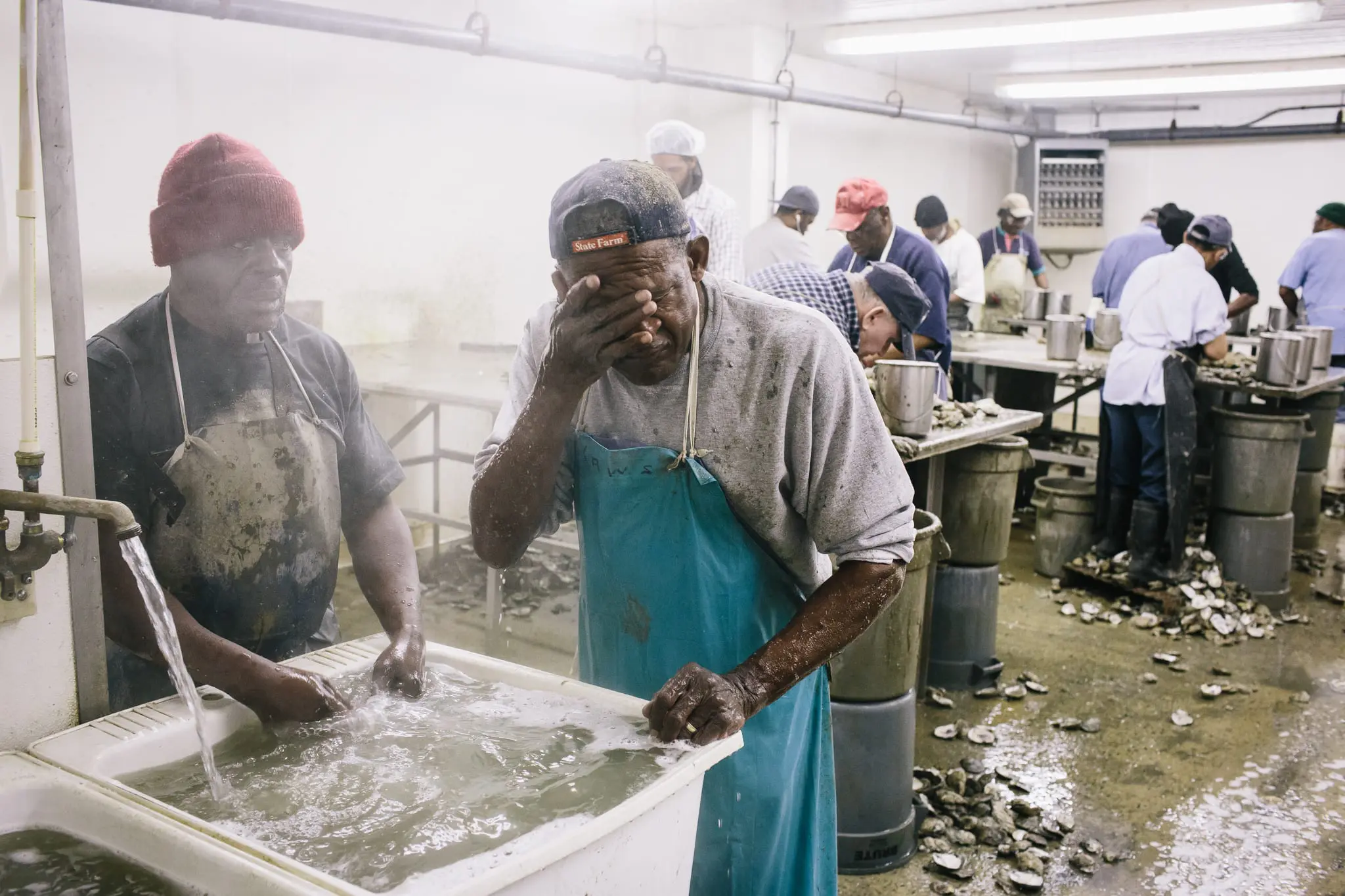 Oyster shucker Billy Laws washes his face after his shift.