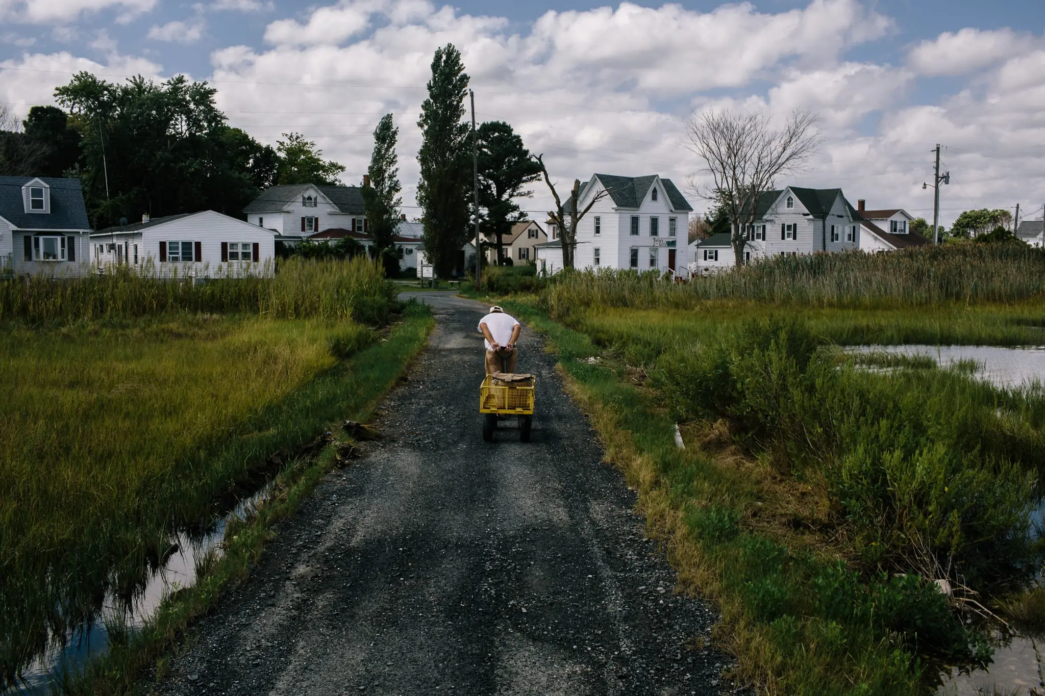 David Laird wheels a crate of crabs back to his home.