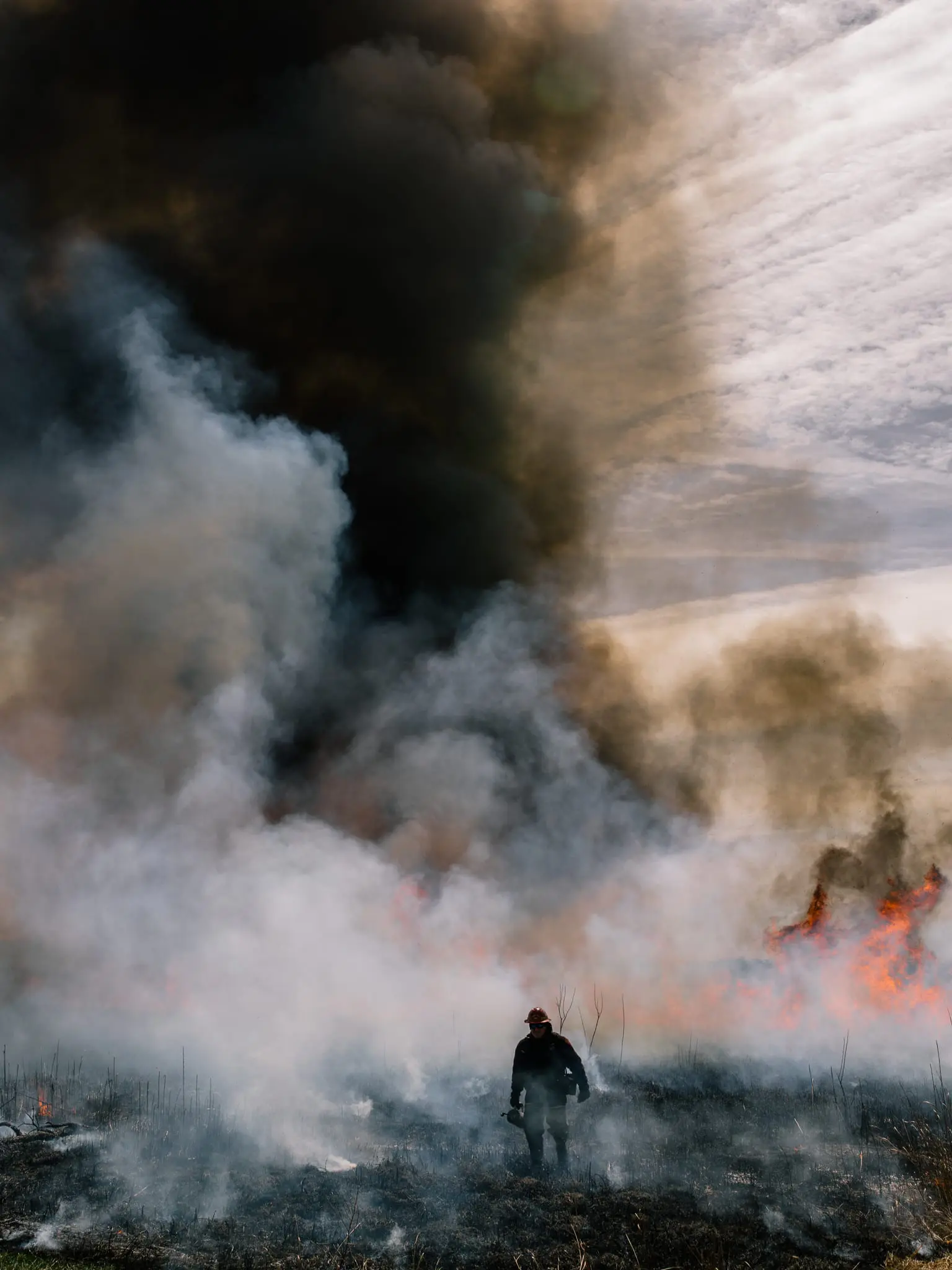 A firefighter performs a controlled burn on the marshes of Blackwater NWR.