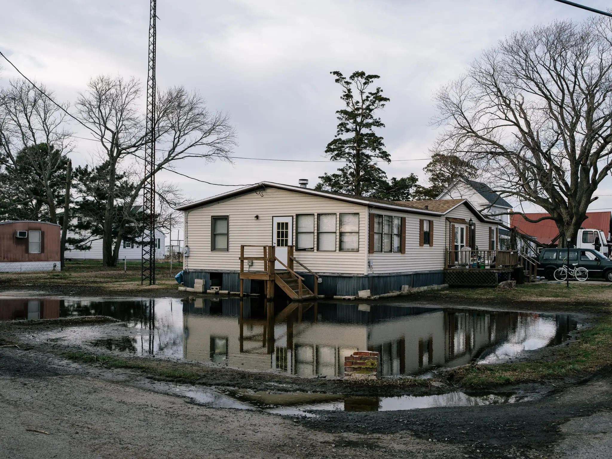 Standing water fills the yard of a home on Smith Island.